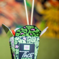 Thai Express chopsticks sticking out of a carton of fresh food