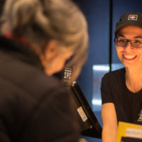 Thai Express Franchise Smiling Employee Serving Guests